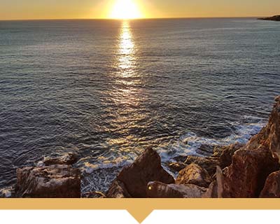 View of the ocean from a rocky cliff.